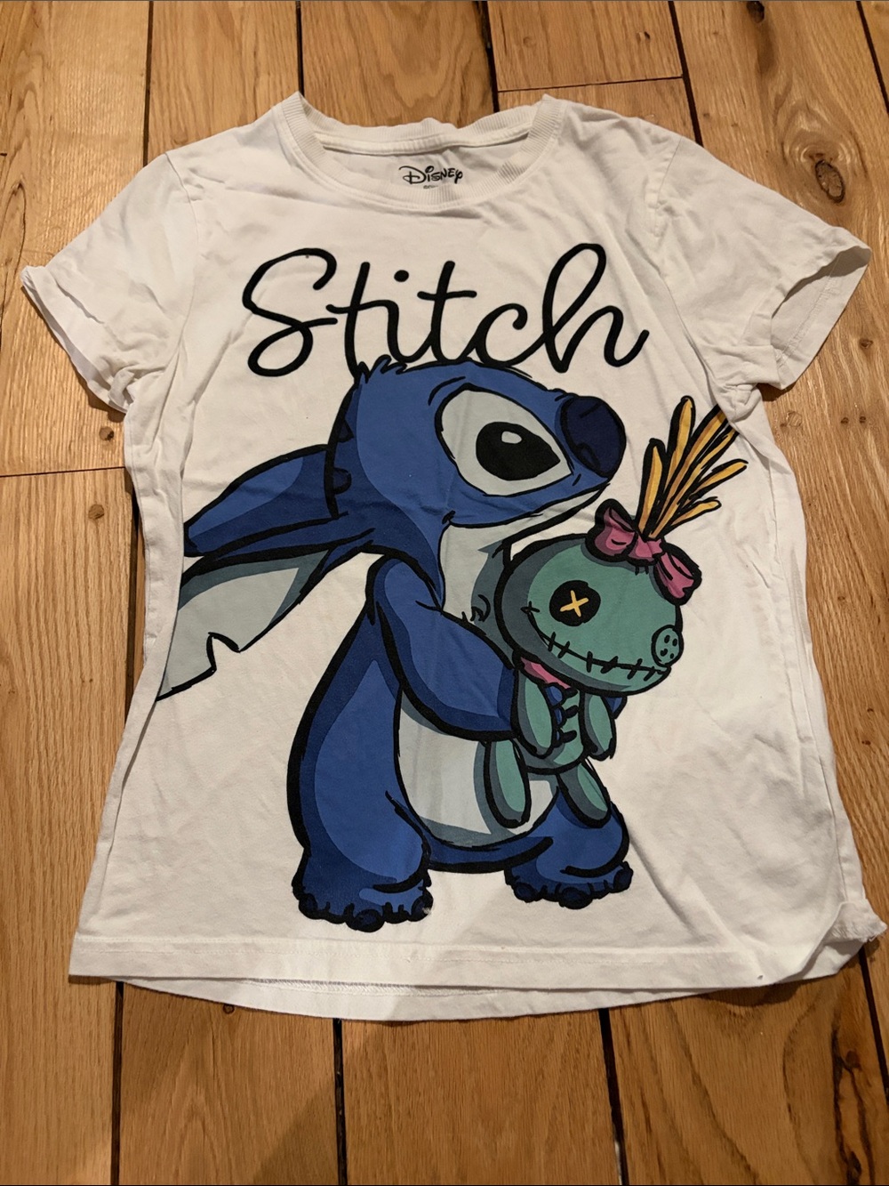 Disney’s White Tee with Blue Stitch Holding Teal Doll